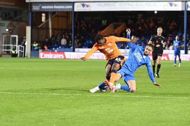 Posh substitute Klaidi Lolos challenges for possession in the FA Cup win over Cardiff City. Photo David Lowndes