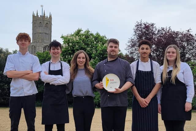 The team at The Falcon Inn at Fotheringhay, with their Two Rosettes plate from AA.
