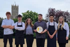 The team at The Falcon Inn at Fotheringhay, with their Two Rosettes plate from AA.