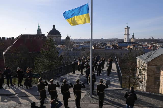 February 24 will mark the first anniversary of the war in Ukraine. Here, an honour guard raises the Ukrainian flag in Lviv, Ukraine. (Image: Getty Images)