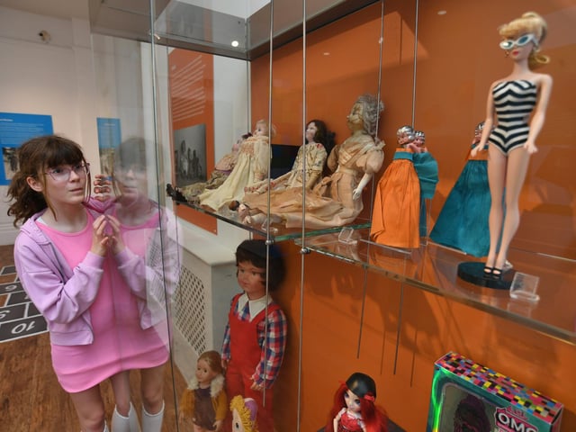 Issy Patten looking at the dolls display.