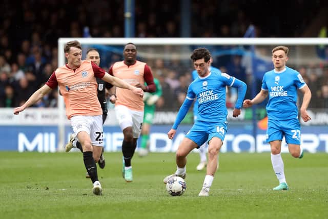 Posh forward Joel Randall in action with Owen Moxon of Portsmouth. Photo Joe Dent/theposh.com.