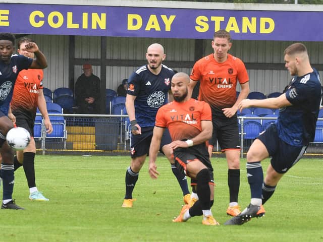 Josh McCammon (orange) of Peterborough Sports was unlucky not to be awarded a penalty at Tamworth.