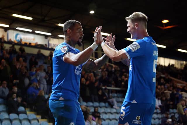 Jonson Clarke-Harris of Peterborough United celebrates scoring his goal with Josh Knight. Photo: Joe Dent.