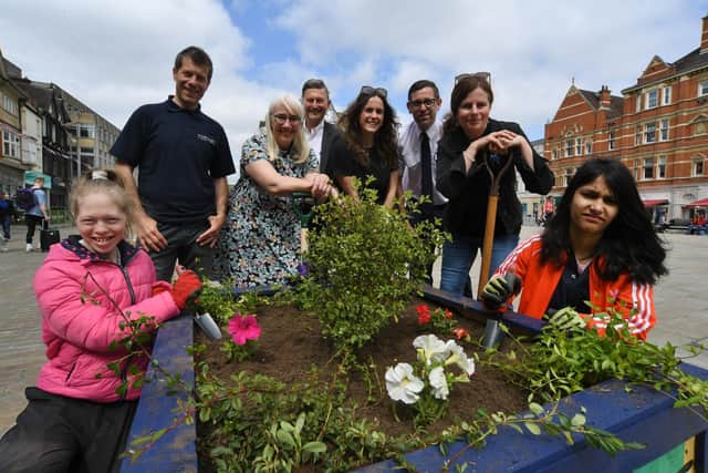 Planters being installed at Cathedral Square with pupils from Marshfields School, Revd Michelle Dalliston from St John's Church, Cllr Steve Allen and Pep Cipriano and his team