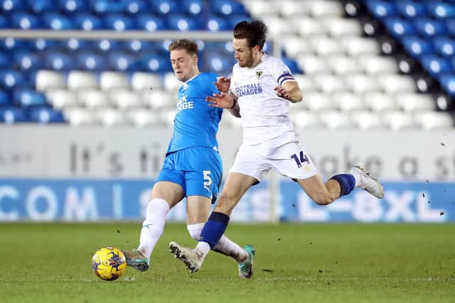 Josh Knight of Peterborough United in action with Armani Little of AFC Wimbledon. Photo: Joe Dent/theposh.com.