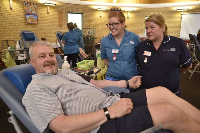 David Stevenson gives his 100th pint of blood with nurses Karen Pledger and Val Outhwaite