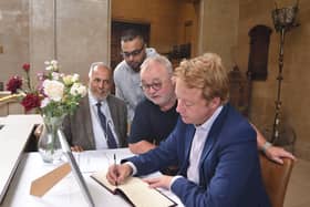 Charles Swift Book of Condolence at the Town Hall being signed by Cllr Gul Nawaz, Sabeel Ahmed, Wayne Fitzgerald and MP for Peterborough Paul Bristow