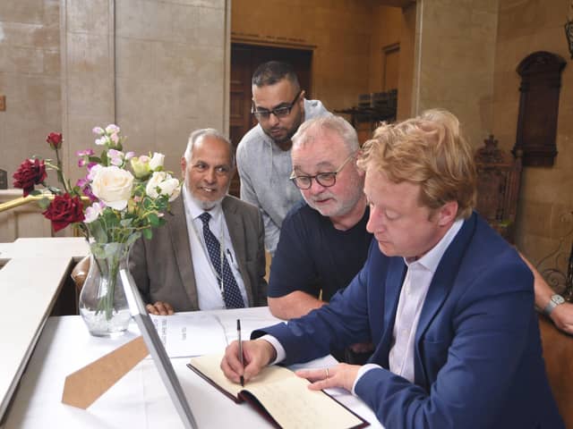 Charles Swift Book of Condolence at the Town Hall being signed by Cllr Gul Nawaz, Sabeel Ahmed, Wayne Fitzgerald and MP for Peterborough Paul Bristow