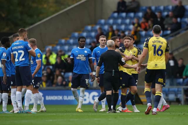 Tempers flared between Oxford United and Peterborough United players as Matty Taylor of Oxford United was sent off for violent conduct. Photo: Joe Dent/theposh.com