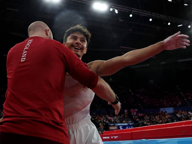Jake Jarman celebrates with his coach after winning Vault Gold at the Commonwealth Games in Birmingham. (Photo by Al Bello/Getty Images).