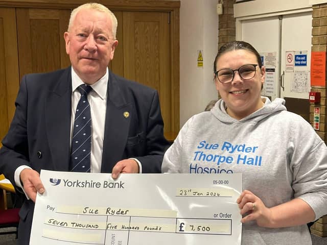 Martyn Sharp of the Royal Order of Antediluvian Buffaloes (Peterborough Province) hands over a cheque for £7,500 to Cheyenne Smith of Sue Ryder.
