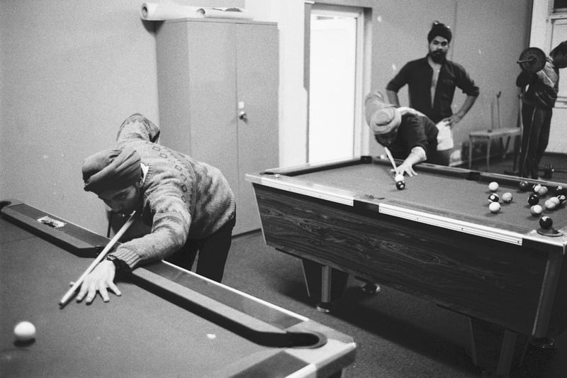 Boys play pool and exercise with free weights at the Asian Cultural Centre in Peterborough, 1985.