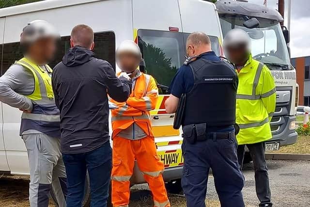 Officers talking to workers on a construction site in Cambridgeshire