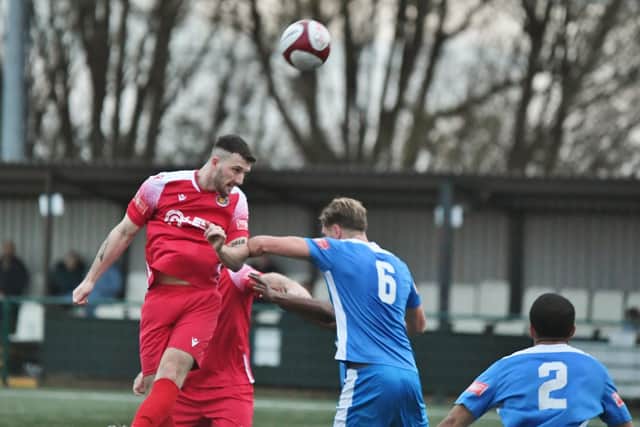 James Blunden (red) heads Stamford AFC's second goal at Yaxley (Photo: David Lowndes).