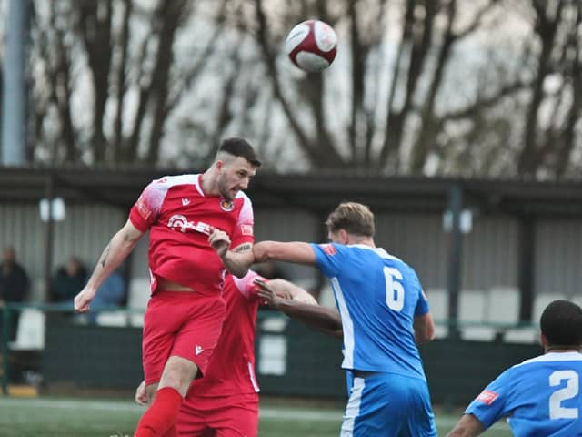 James Blunden (red) heads Stamford AFC's second goal at Yaxley (Photo: David Lowndes).