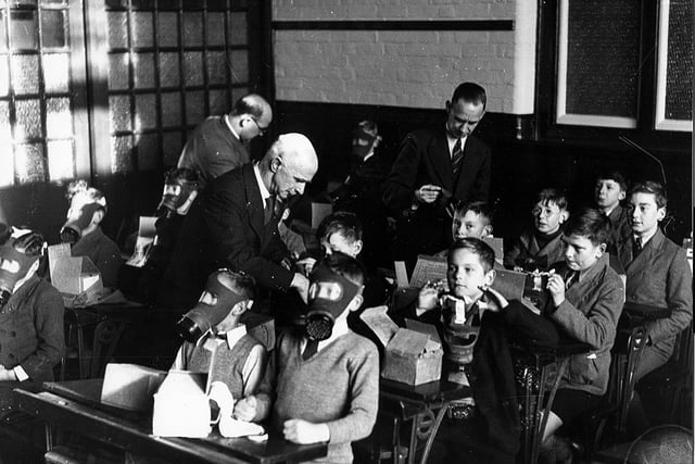 Children are taught to put on their gas masks at a school in Highland Road, Eastney.