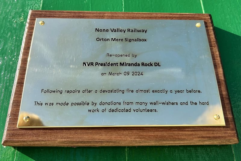 The official plaque acknowledges the efforts of "dedicated volunteers" and "well-wishers."