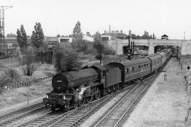 A steam service leaving Peterborough East station, under Town Bridge and then up towards Peterborough North station.