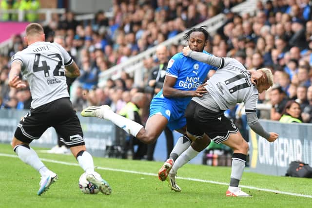 Luke Thomas halts the progress of Ricky-Jade Jones during the Posh v Bristol Rovers match, Photo: David Lowndes.