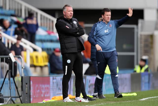 Peterborough United manager Darren Ferguson watches on alongside Exeter City manager Gary Caldwell. Photo: Joe Dent/theposh.com.