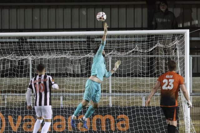 Weekend football action as Peterborough Sports goalkeeper Peter Crook makes a save during a 1-1 National League North draw with Spennymoor Town at PIMS Park. Photo Darren Wiles.