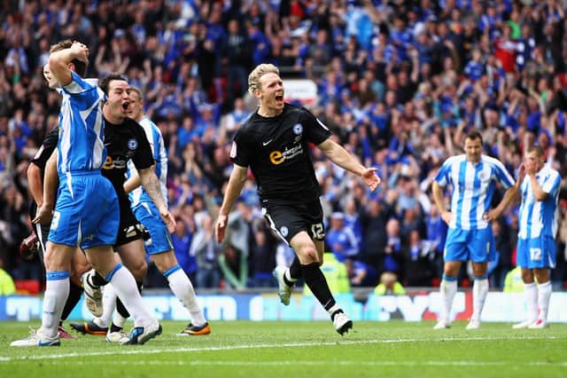 Craig Mackail-Smith celebrates scoring the second goal of the game as Posh clinch play-off success against Huddersfield Town.