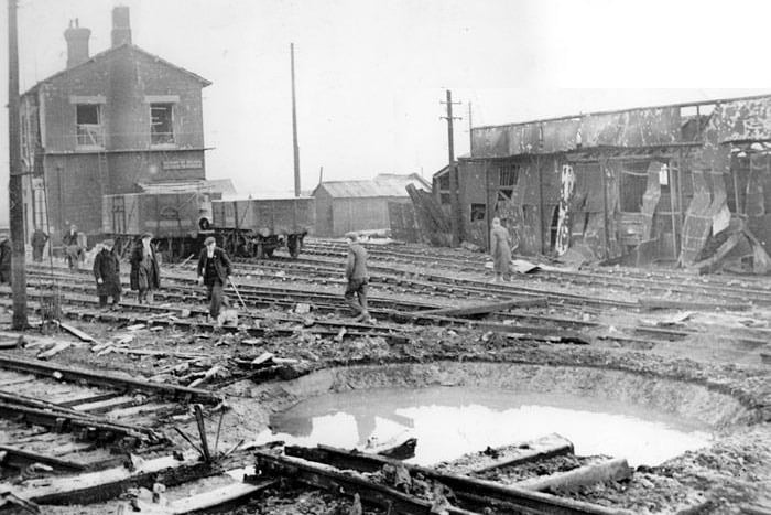 Striking images showing the aftermath of a German bombing raid with workers trying to put right the considerable damage made to the New England yards near to the New England Loco Shed.