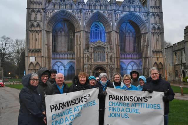 Parkinson's UK supporters at Peterborough Cathedral which is lit up blue to support the charity.