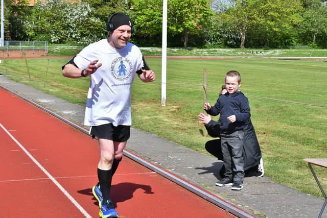 Jason Lovett doing a super marathon at the Embankment track -  cheered on by son Anakin Lovett and his mum Lisa Sachse