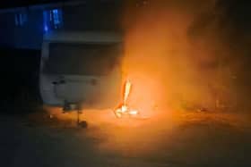The caravan on fire in a car park in Peterborough
