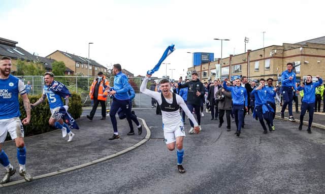 Harrison Burrows celebrates a Posh promotion in May 2021.
