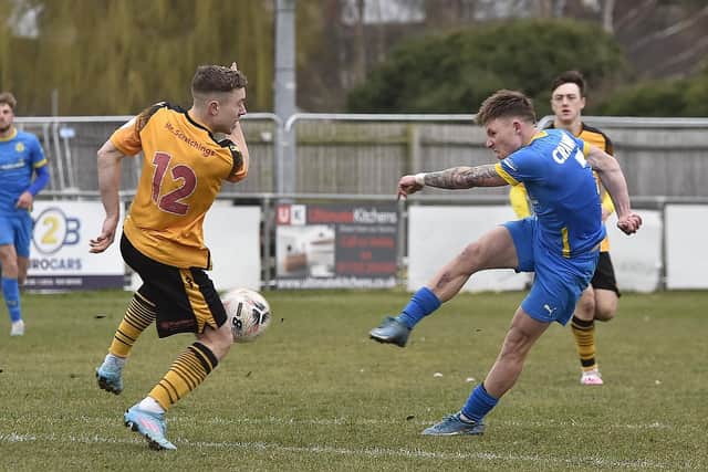Jordan Crawford of Peterborough Sports (blue) shoots at goal v Bradford Park Avenue. Photo: David Lowndes.