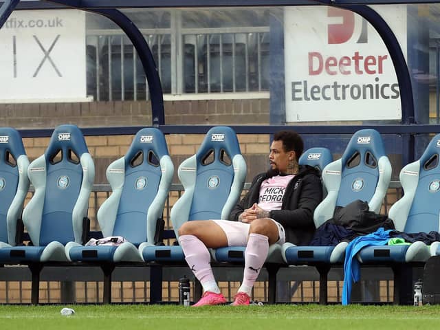Jonson Clarke-Harris of Peterborough United sits on the bench. Photo: Joe Dent/theposh.com