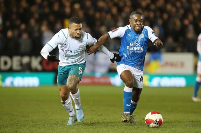 Posh midfielder Jeando Fuchs in action against Gabriel Jesus of Manchester City in an FA Cup tie in March 22. Photo: Joe Dent/theposh.com.