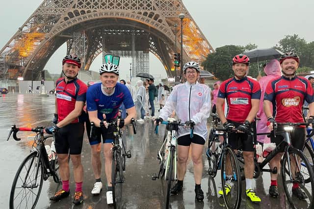 Some of the soaked riders as they reached the Eiffel Tower.