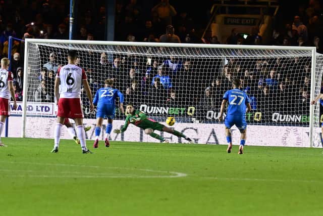 Jamie Reid (hidden) sends Posh 'keeper Alex Bass the wrong way from the penalty spot for the only goal of the game.