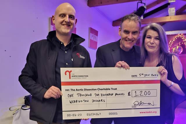 Trustee of Aortic Dissection Charitable Trust, Catherine Fowler and her husband Keith receive a cheque for £1,200 from Werrington Joggers chairman, Rod McDonald (centre).