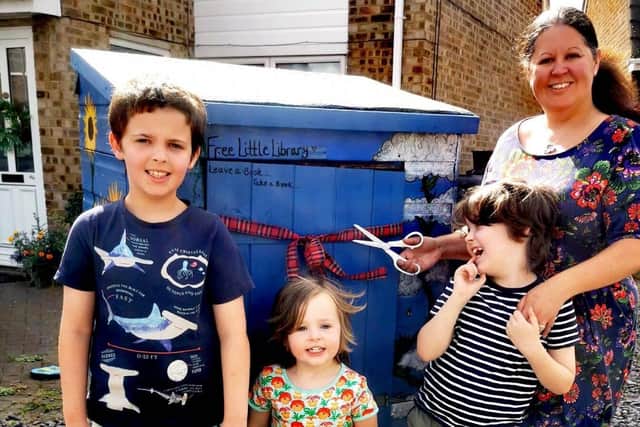 Nicola pictured cutting the ribbon with her three boys age 8, 7, and 3.