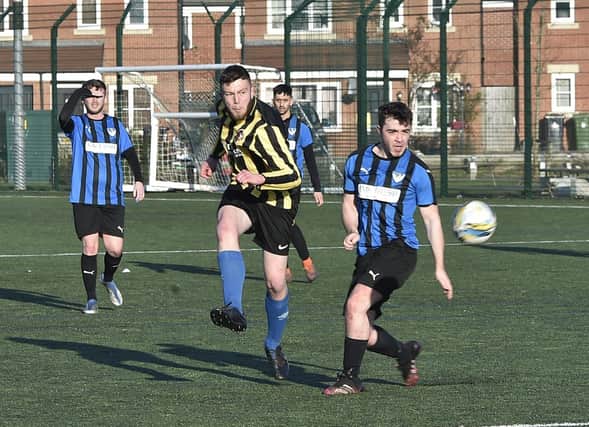 Whittlesey Athletic A score their second goal in a 6-2 win at FC Hampton Reserves (blue). Photo David Lowndes.