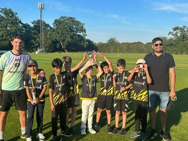 The winning Peterborough Town Under 9 team with coaches Lewis Bruce (left) and Vidit Matta.