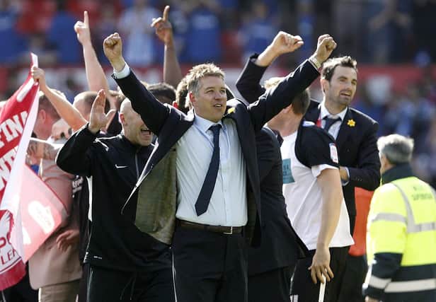 Posh boss celebrates promotion from League One at Old Trafford in May, 2011. Photo: Peter Byrne/PA.