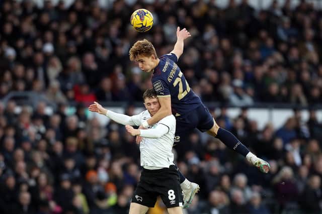 Hector Kyprianou of Peterborough United battles in the air with Max Bird of Derby County. Photo: Joe Dent.