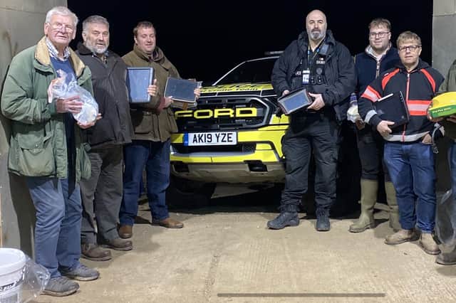 PC Hellary from Cambs RCAT (far right) delivering GPS systems to farmers with PC Hutch Hutchings from Northants Rural Crime Team.