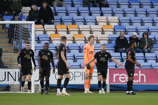Dan Butler of Peterborough United rallies his team-mates after conceding the second goal to Shrewsbury Town. Photo: Joe Dent.