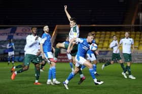 Kell Watts (in the air) in action when on loan for Plymouth against Posh in 2020. Photo: Joe Dent/theposh.com.