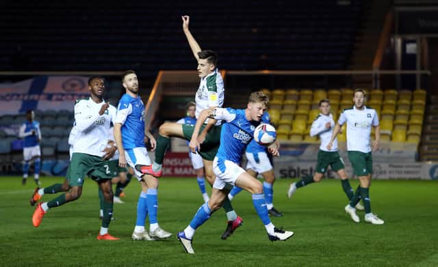 Kell Watts (in the air) in action when on loan for Plymouth against Posh in 2020. Photo: Joe Dent/theposh.com.
