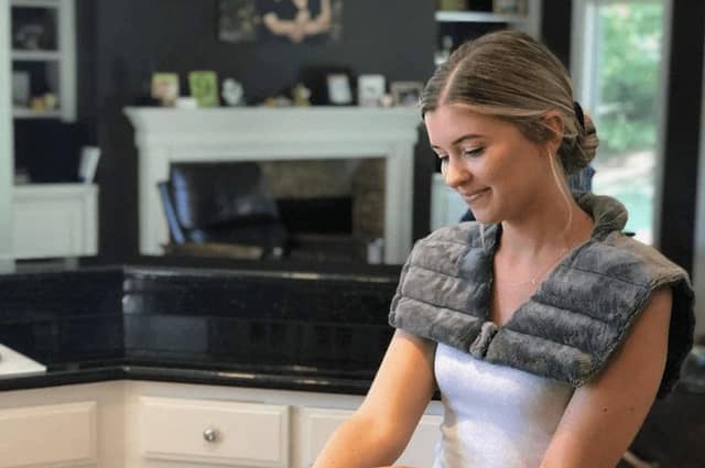 Now you can stay warm at your desk, at home or in the car with a wearable heat pad that drapes over your shoulders (Photo: Huggaroo)