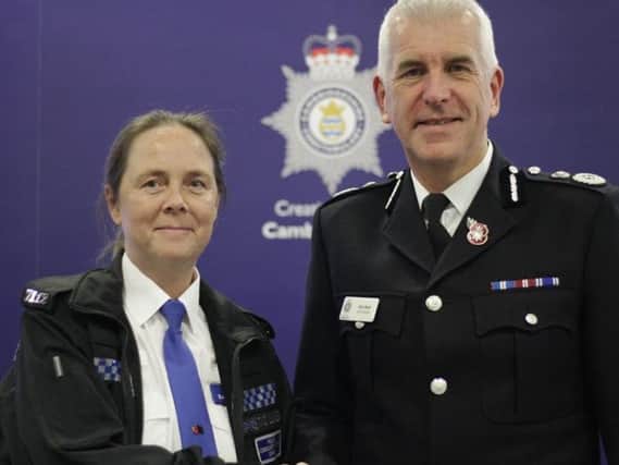 PCSO Sally Lunness receiving her commendation from Cambridgeshire Police's Chief Constable Alec Wood