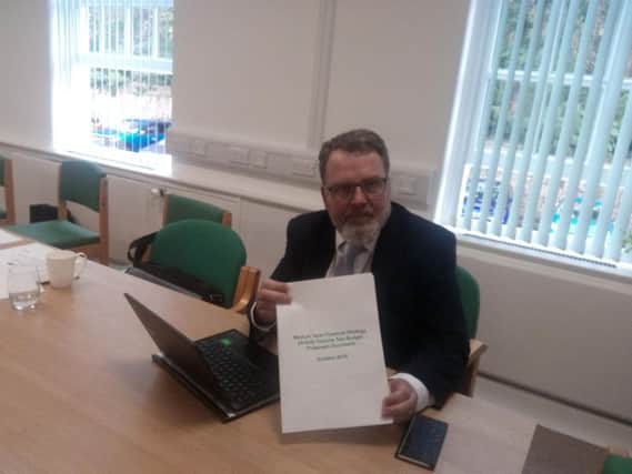 Cllr David Seaton with a copy of the budget
